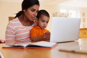 Mother helping child in studying