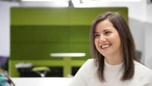 Woman smiling in a modern workplace